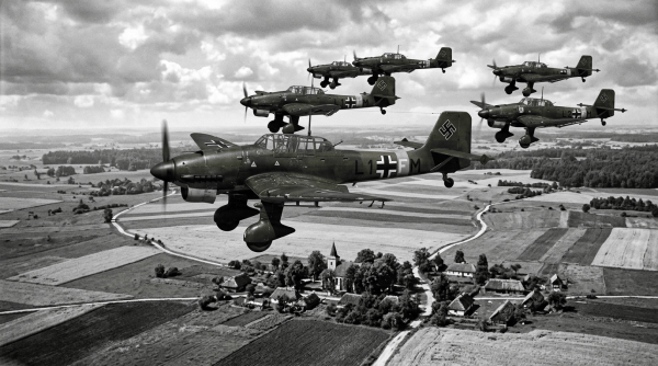 Formation of German World War II dive bombers over farmland